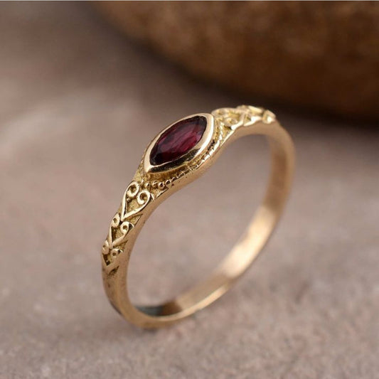 Goldener vintage-ring mit rotem kristall